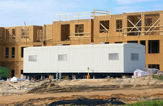 workers studying blueprints in a temporary rental office in Tornillo TX